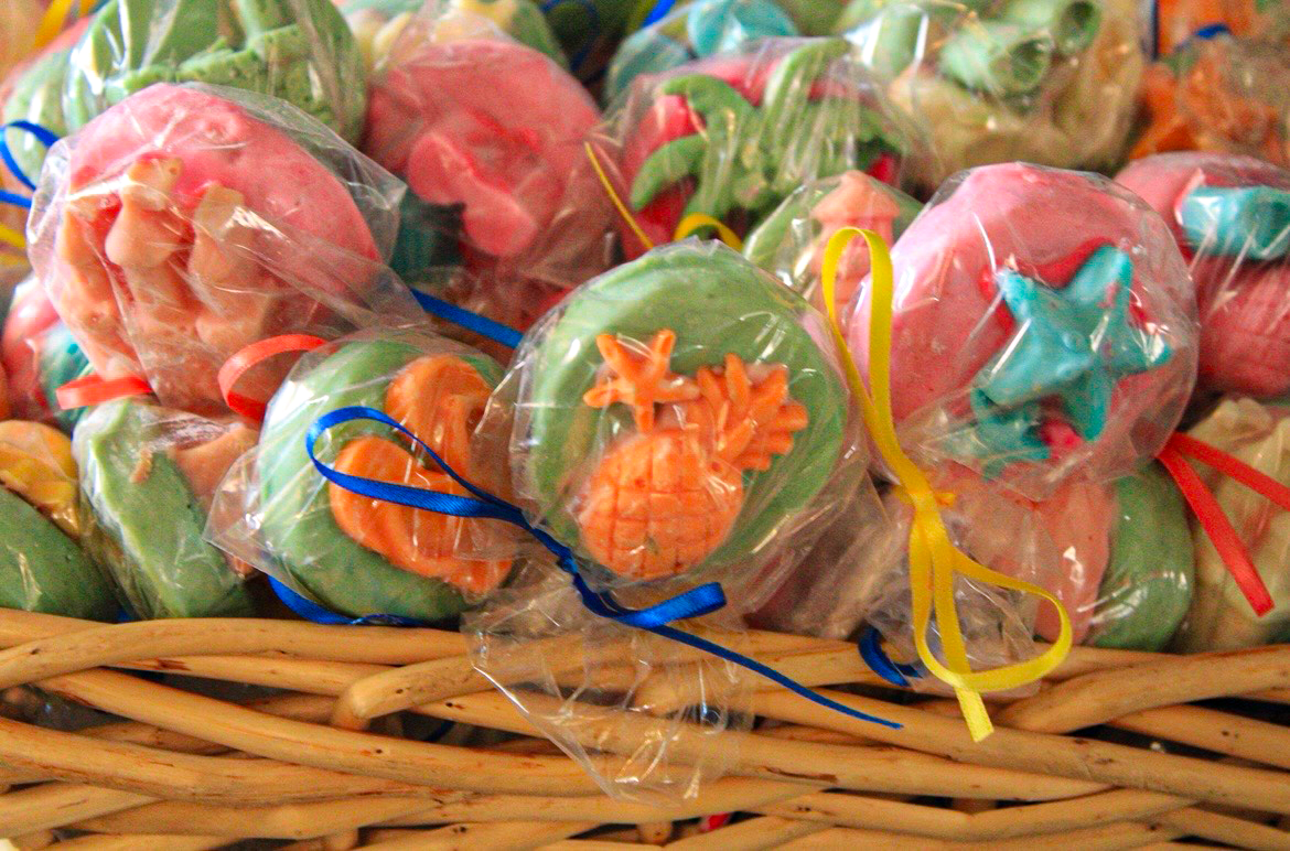Decorated cake pops in a basket by Angela's Sweets and Treats